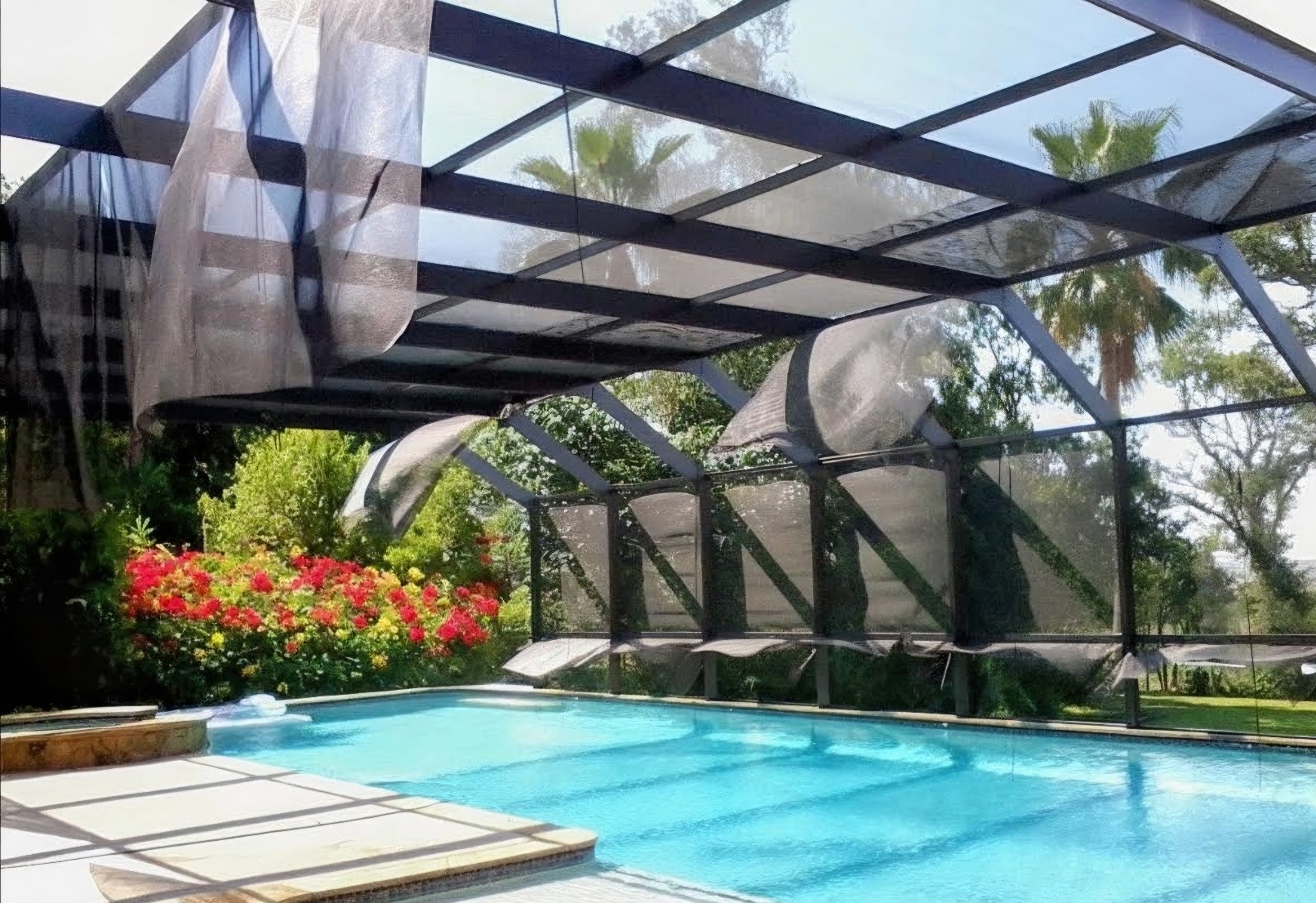Before pool screen repair showing torn and worn pool cage screen panels in Northwest Florida